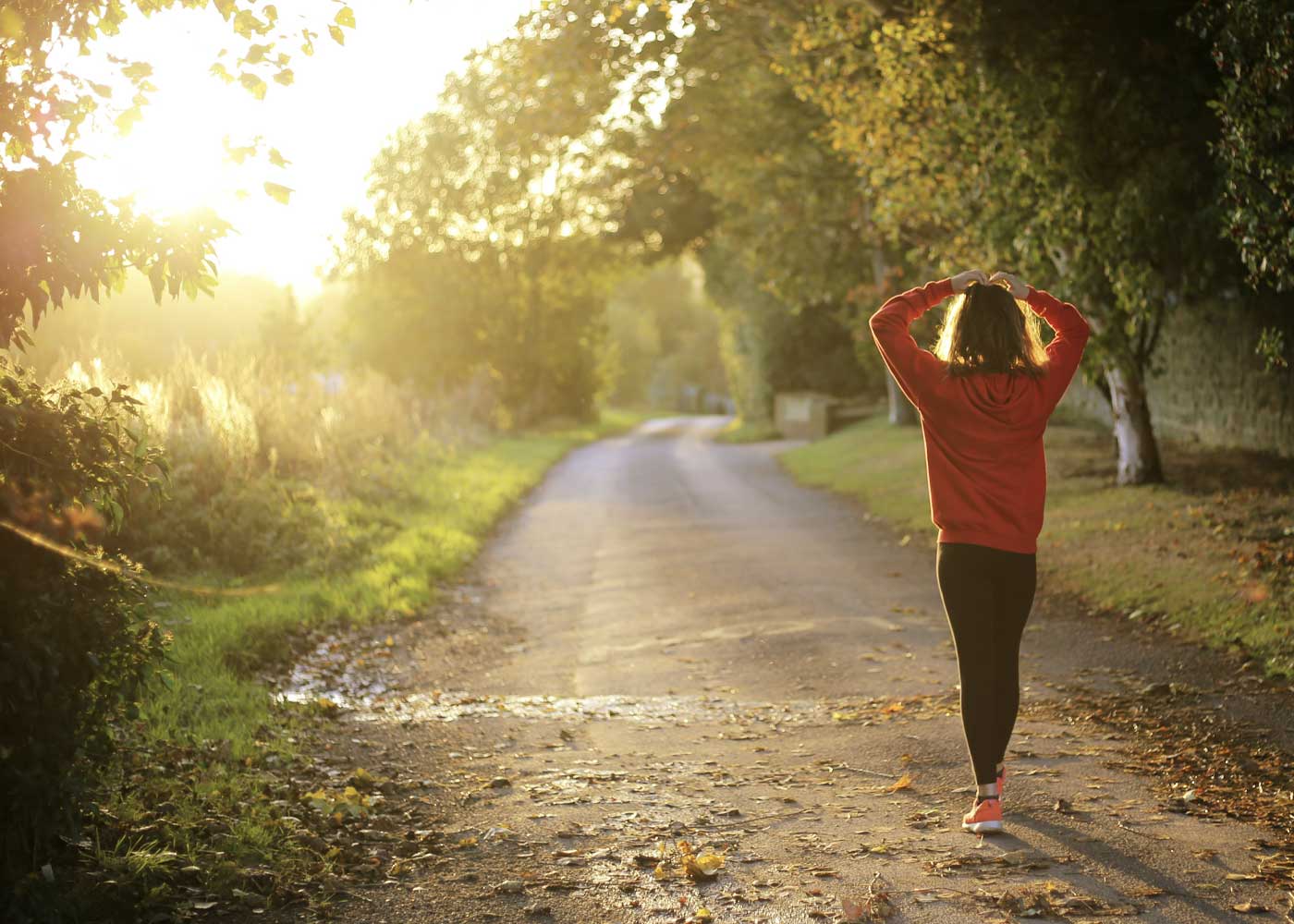 scf_health-and-wellness walking on an outdoor trail in the sunset